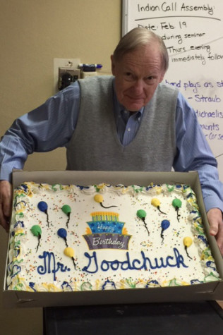 Mr. Goodchuck holds his birthday cake. 