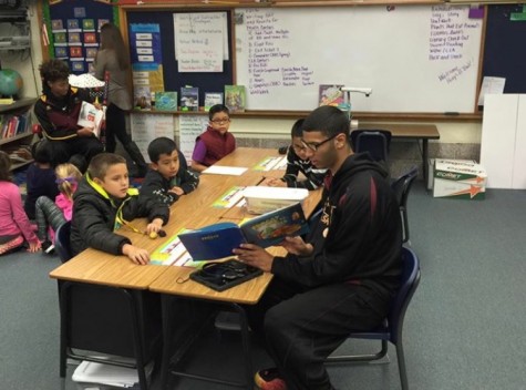 Senior Isaiah Nunnery reads to children as part of the TOC experience. 
