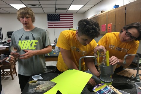 Juniors Tyrone Wynn, Jace Armstrong and Alex Davis create their bottle rocket.