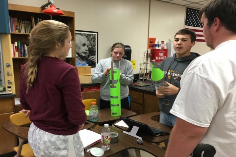 Juniors Katie Fross, Rachel Taylor and Thomas Harman create their bottle rocket. 