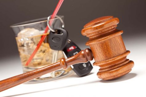 Gavel, Alcoholic Drink & Car Keys on a Gradated Background - Drinking and Driving Concept.