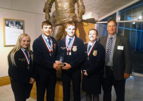 Juniors Breanna Park, Lane Pfannenstiel, Conrad Vajnar and Katie Fross smile for a picture with FFA instructor Curt Vajnar.