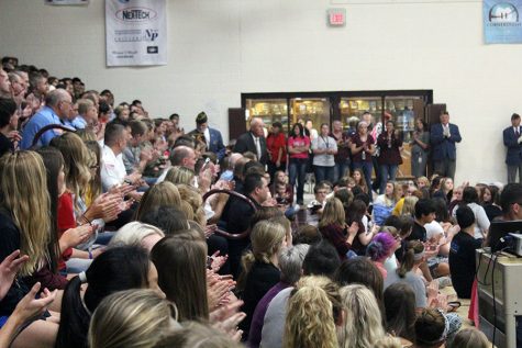 The student body claps for each individual special guest at the assembly.