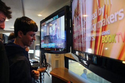 Junior Reese Lovell views the screens in the C-SPAN bus.