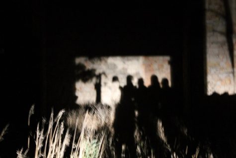 The shadows of each newspaper member against the church walls.