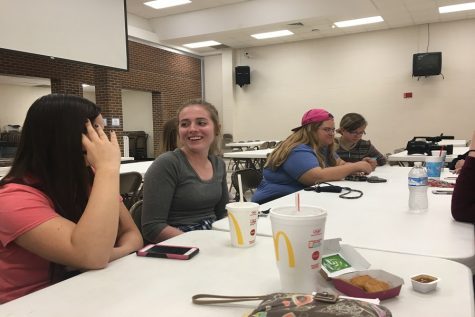 Seniors Sierra Eichman, Veronika Fuller, Rachelle Lumpkins and Alyana Arnhold wait for instructions in the cafeteria, where the tallying for Kids Vote Kansas took place. 