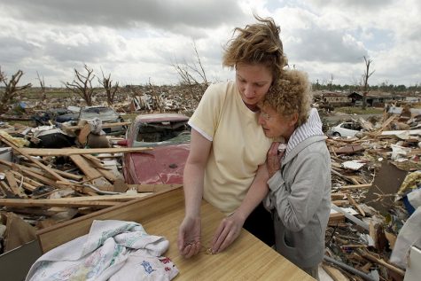 Beverly Winans hugs her daughter Debbie Surlin while salvaging items from Winans' devastated home in Joplin, Mo. Wednesday, May 25, 2011. Winans and her husband rode out the EF-5 tornado by hiding under a bed in the home. The tornado tore through much of the city Sunday, damaging a hospital and hundreds of homes and businesses and killing at least 123 people. (AP Photo/Charlie Riedel)