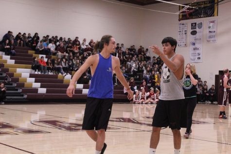 Junior Nick Silva and senior Michael Reyes walk off the court after being defeated by the teachers.