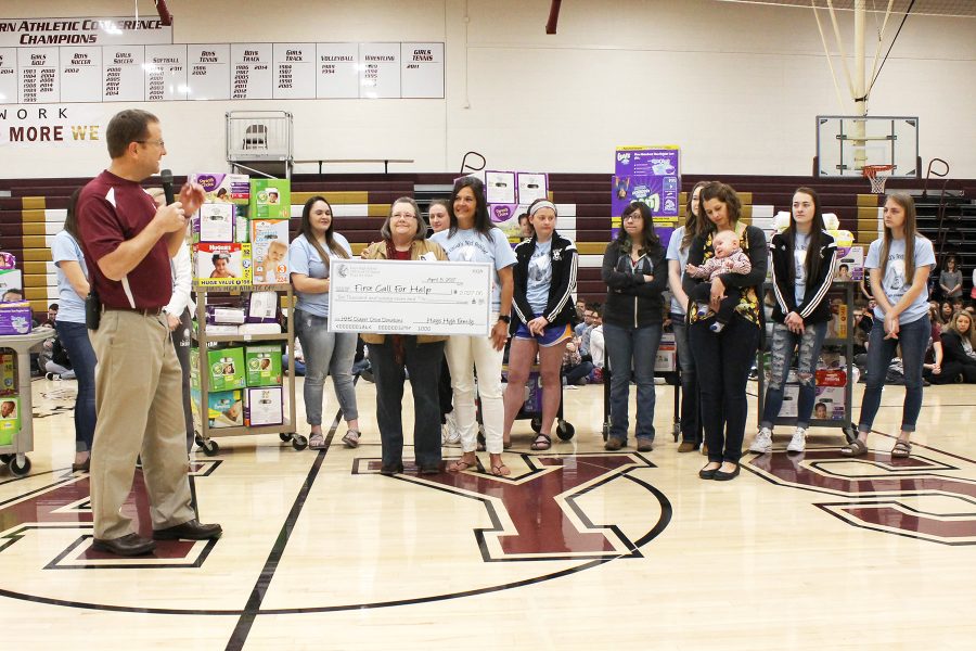 Instructor+Sue+Ann+Tebo+and+her+family+studies+students+are+introduced+by+principal+Martin+Straub.+The+class+presented+Ellis+County+First+Call+for+Help+with+a+contribution+of+over+7%2C000+diapers.+