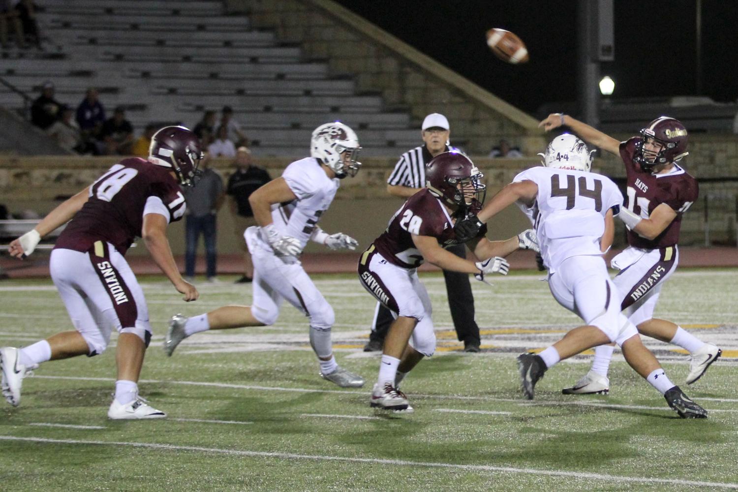 Senior Hunter Browns throws a pass and hopes to hit someone for a touchdown in a recent game against the Garden City Buffalos. The Indians lost to the Dodge City Red Demons on Oct 6.
